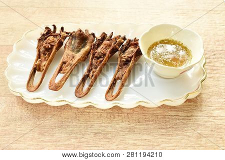 Deep Fried Duck Beak Dipping Spicy Sauce On Plate