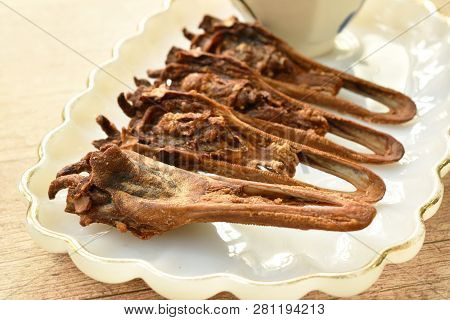 Deep Fried Duck Beak Dipping Spicy Sauce On Plate