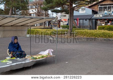 Hida Takayama, Gifu, Japan - December 2018 : Seller Woman Sitting Sell Local Farm Products Such As V