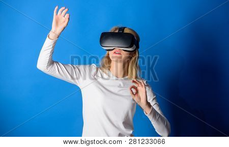 Beautiful Woman Wearing Virtual Reality Goggles In Studio. Woman Using Virtual Reality Headset. Happ
