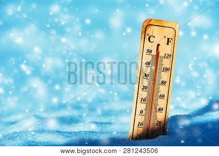 Cold Temperature Below Zero On Thermometer In Snow During Winter Season