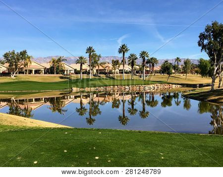 A Beautiful View From The Tee Box Of A Difficult Par 3 That Requires A Shot Over The Water Onto An I