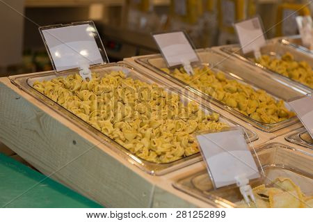Raw Cappelletti And Tortellini Italian Pasta In Containers For Sale.