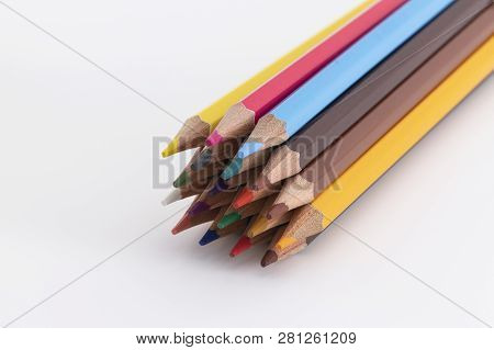 Wooden And Colored Pencils On A White Background