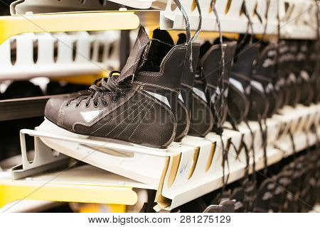 Rows Of Black Ice Skates, Selective Soft Focus. Hire Of Winter Sports Equipment. Shelves With Skates