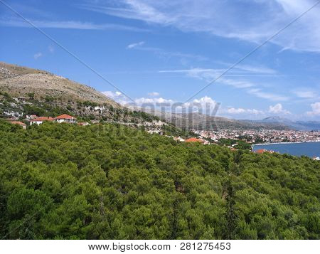 View Of Picturesque Landscape With Mountains, Bright Green Foliage, Pinnate Clouds In The Sky At The