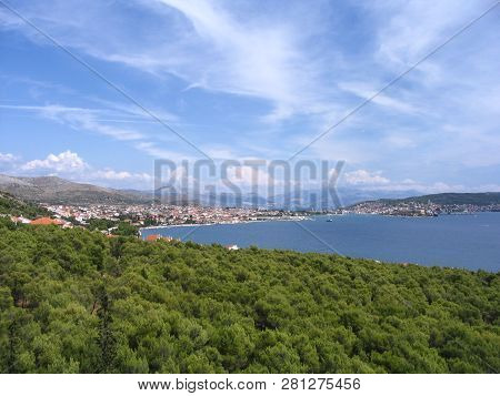 View Of Picturesque Landscape With Blue Sea, Bright Green Foliage, Old City With Tiled Roofs At Dist