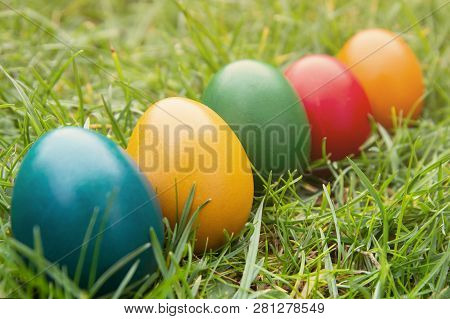 Easter Colorful Eggs In Fresh Green Grass. - Yellow, Green, Red, Orange And Blue Eggs. Spring, Easte