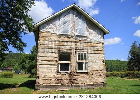 An Old Log Cabin Built By Early Settlers Showing Dovetail Construction
 And Chinking Between The Log