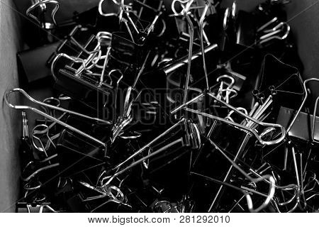 Box of binder clips binderclips office supplies of paperclips on desk