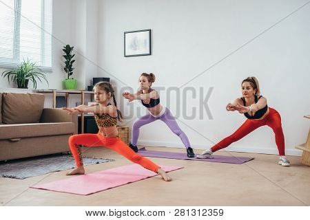 Women Squatting And Stretching Legs Doing Squat Exercises Working On Butt Muscles