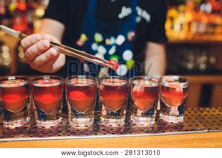 Bartender Man Making Hot Alcohol Shots On The Bar In The Pub With A Professional Burner. The Bartend