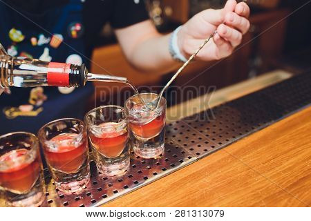 Bartender Man Making Hot Alcohol Shots On The Bar In The Pub With A Professional Burner. The Bartend