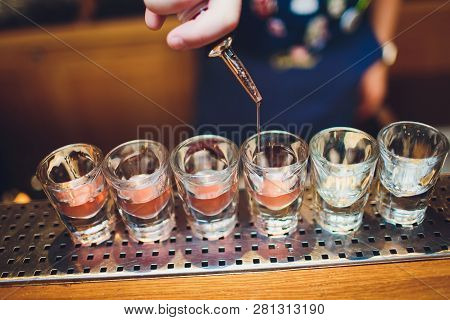 Bartender Man Making Hot Alcohol Shots On The Bar In The Pub With A Professional Burner. The Bartend