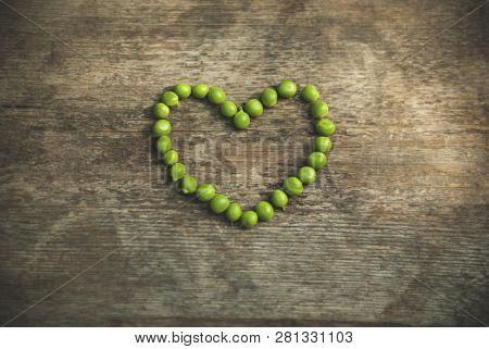 Heart Shaped Peas Green Colors, Wooden Background Grey Colors