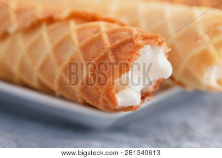 Gaufres de Montcuq, rolled wafers with cream filling  on a white dish