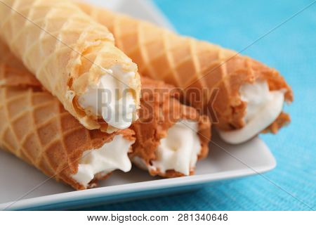 Gaufres de Montcuq, rolled wafers with cream filling  on a white dish