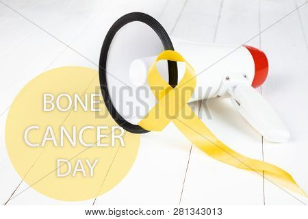 Yellow Ribbon Symbolic Color For Sarcoma Bone Cancer Awareness And Suicide Prevention On Aged Wood W