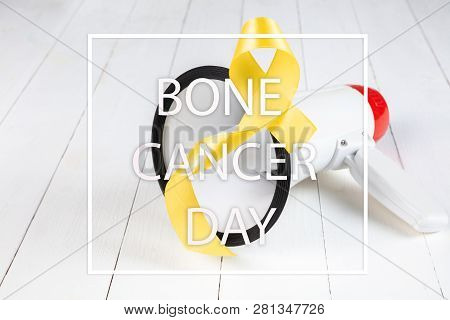 Yellow Ribbon Symbolic Color For Sarcoma Bone Cancer Awareness And Suicide Prevention On Aged Wood W