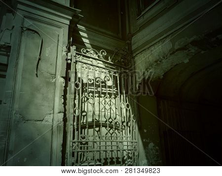 Old Building. Forged Openwork Gates. Shadow On Thehouse.