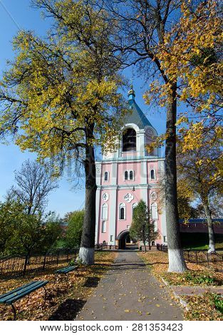 Bell Tower Of  Sviato-troitskyi Monastery On A Background Of Autumn Trees In Gustynya. Chernihiv Reg