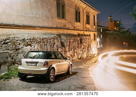 Terracina, Italy - October 15, 2018: White Color Hatch Pre-facelift Mini Cooper R56 Car Parked On Ba