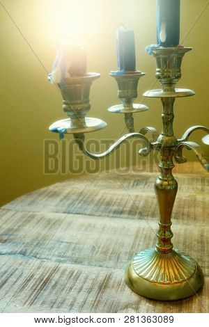 Detail of a candle holder with several used candles