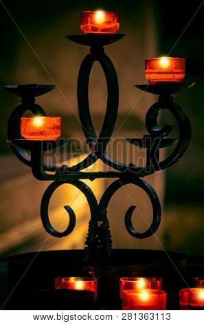 Detail of a candle holder with several used candles