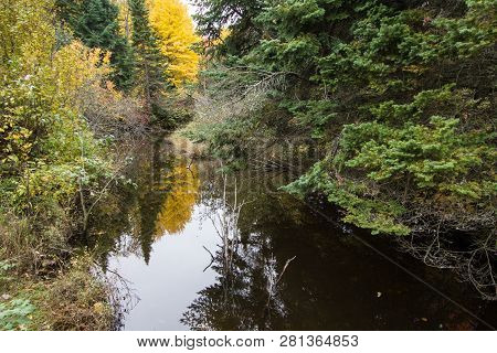 Autumn River Reflections. Beautiful Autumn Foliage Reflected In The Water Of A Small River In The Hi