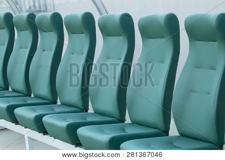 Empty Coach And Reserves Green Bench On A Football Stadium