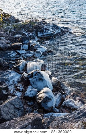 Icy Stones On Beach Near Lake Vattern
