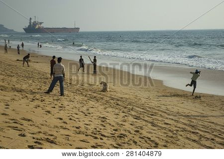 The Boys Play Cricket On The Indian Ocean On Candolim Beach. India, Goa - January 27, 2009