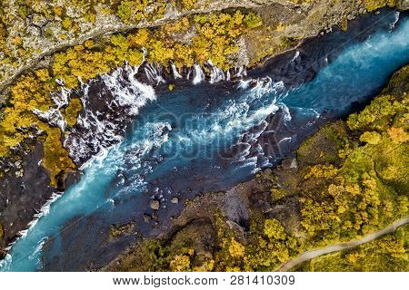 Aerial View Of Autumn Foliage At Hraunfossar Waterfalls In Husafell, West Iceland
