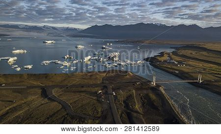 Aerial View Of Icebergs Floating Out To Sea At Jokusarlon Glacial Lagoon, Southeast Iceland.