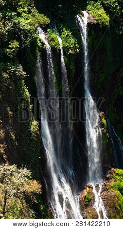 Waterfall Coban Sewu In Java, Indonesia. Waterfall In Tropical Forest By Drone Tumpak Sewu