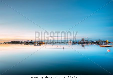 Helsinki, Finland. Landscape With City Pier, Jetty At Winter Sunrise Or Sunset Time. Tranquil Sea Wa
