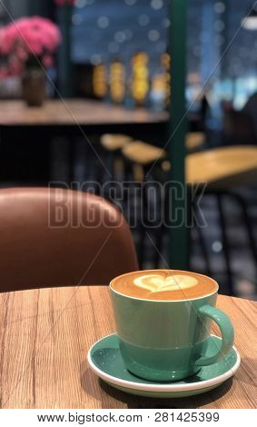 Mug Of Hot And Aromatic Coffee In A Cozy Cafe.