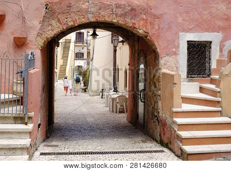 Mother And Father With Their Son Walking Together In Italian Picturesque Village. San Felice Circeo,