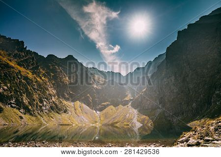 Tatra National Park, Poland. Calm Lake Czarny Staw Under Rysy And Summer Mountains Landscape. Sunshi