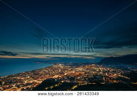 Terracina, Italy. Top View Skyline Cityscape City In Night Illuminations.