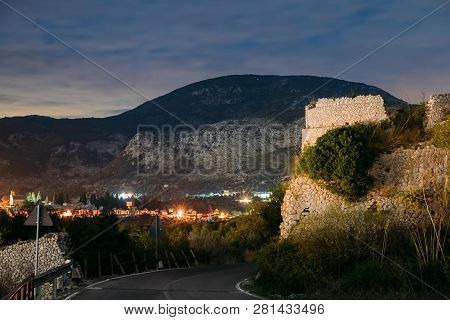 Terracina, Italy. Night View Of Road Near Remains Old Roman Fortress Wall With Towers.
