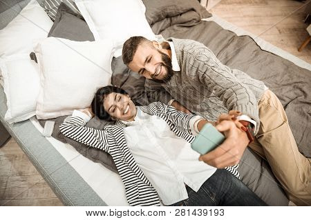 Beaming Positive Couple Making Selfie With Smartphone