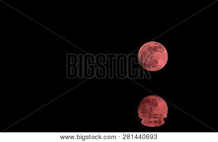 Reflections On The Ocean Of A Shining Full Red Moon In The Dark Night