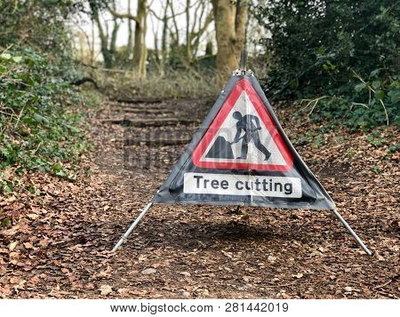 Caution tree cutting sign in managed woodland tree surgery