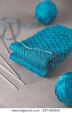 A Pair Cozy Blue Socks With Two Ball Of Yarn And Five Stainless Steel Double Pointed Needles