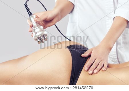 The Doctor Does The Rf Lifting Procedure On The Legs, Buttocks And Hips Of A Woman In A Beauty Parlo