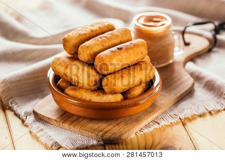 Cheese Fingers, Typical Venezuelan Appetizer Called Tequeños Accompanied With A Pink Sauce On A Wood