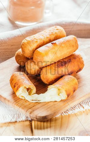 Cheese Fingers, Typical Venezuelan Appetizer Called Tequeños Accompanied With A Pink Sauce On A Wood