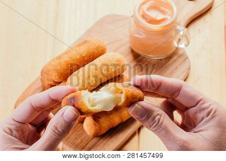 Woman's Hands Holding An Appetizing And Delicious Tequeño Typical Snack Of Venezuelan Food