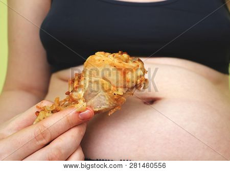 Fat Woman Holding And Eating Fried Chicken. Food And Healthcare Concept